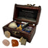 An open decorative wooden treasure chest display box containing assorted crystals, stones, a shell, and a starfish, with a printed insert in the lid. Two additional crystals are placed in front on a white background.